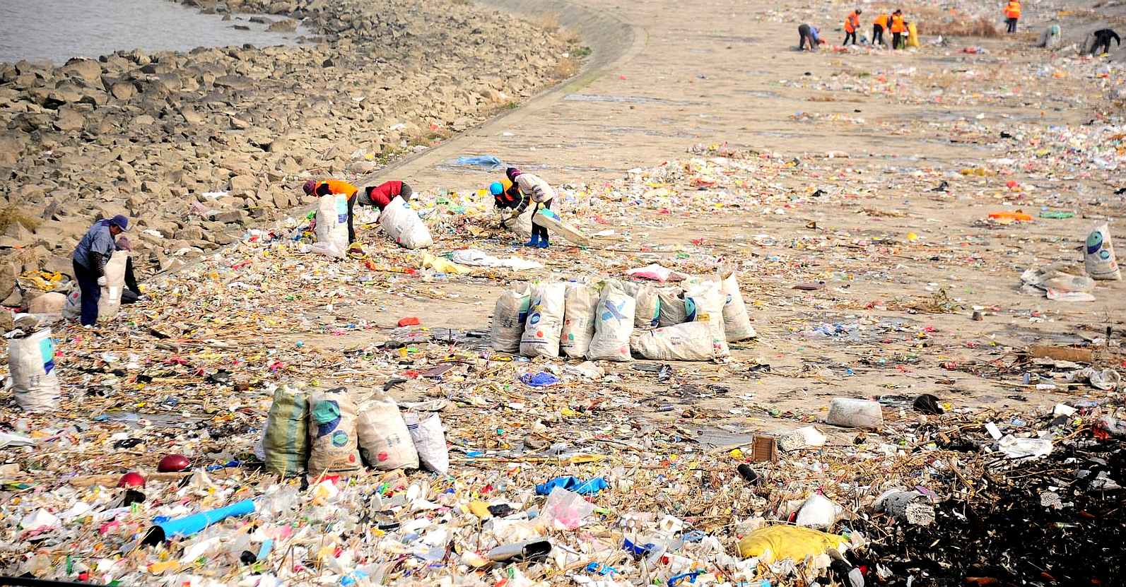 Fishing nylon net on the sand. Garbage on the beach. Dirty sea